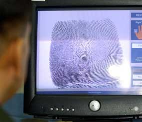 U.S. Bureau of Customs and Border Protection senior agent Arnie Villarreal looks at a fingerprint on the new Automated Fingerprint Identification System during a demonstration at the Brown Field Station along the U.S-Mexico border.