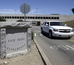 A vehicle drives by the main entrance to California State Prison, Sacramento, Monday, May 16, 2016, in Folsom, Calif.