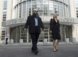 Imam Ahmad Afzali, left, who pleaded guilty to lying to the FBI, leaves Brooklyn federal court after his sentencing, Thursday, April 15, 2010 in New York. (AP photo)