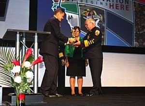 Photo Jamie ThompsonDeputy Chief John Carney recieves the award at FRI on behalf of Chief Robert Perry.