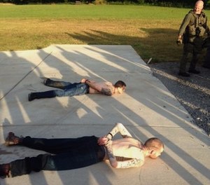 This photo provided by the Tennessee Bureau of Investigation shows the arrest of the two Georgia fugitives Donnie Rowe, top, and Ricky Dubose, bottom, in Christiana, Tenn., Thursday, June 15, 2017.