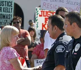 Six officers who were trying to search Thomas' backpack July 5 after reports of break-ins at a Fullerton transit hub got into a fight with the 37-year-old, who later died. In this photo, police stand outside a protest