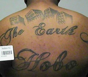 This undated file photo in a court filing provided by the United States Attorney's office in Chicago, shows a gang member's back tattoo that reads 