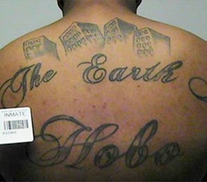This undated file photo in a court filing provided by the United States Attorney's office in Chicago, shows a gang member's back tattoo that reads