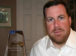 Photo ACLU of MarylandMatthias Goldstein poses with his award from 2003, when the Pikesville Volunteer Fire Co. named him EMS provider of the year.