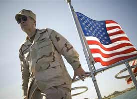Chairman of the Joint Chiefs of Staff, Navy Adm. Mike Mullen rides the ferry to Naval Station Guantanamo Bay,Cuba. Mullen favors closing the prison as soon as possible because he believes negative publicity about prisoner treatment has been "pretty damaging" to the U.S. image. (AP photo)