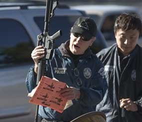 Los Angeles Police officials get an assault weapon back at the LA Memorial Sports Arena in Los Angeles Wednesday, Dec. 26, 2012. Los Angeles police are offering groceries for guns in a buyback program that was moved up in the wake of the Connecticut tragedy. (AP Image)