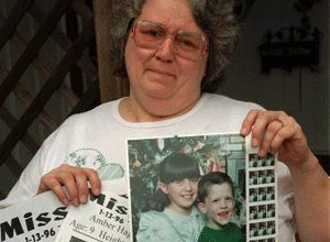 Glenda Whitson holds a picture of her granddaughter, Amber, 9, along with flyers advertising for the whereabouts of the missing child, Monday, Jan. 15, 1996, in Arlington, Texas. Amber was abducted two blocks from Whitson's home while riding her bicycle on Saturday.