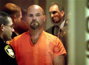 Lawrence Michael Hensley, accused of killing three teen-aged girls and a Bible-studies teacher, is led from a courtroom in the Shelby County Jail in Sidney, Ohio, after pleading innocent to the charges. (Bill Reinke/The Dayton Daily News via AP, File)