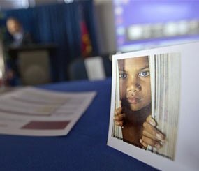 A placard of a child sits on a table during a conference on human sex trafficking Monday, Oct. 31, 2011 in Atlanta. The Georgia Department of Education estimates that about 5,000 girls in the state are at risk for human sex trafficking each year, and many of those children spend some time in a public school.