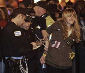 In this Oct. 23, 2011 file photo, a protester gets arrested during an Occupy Chicago march and protest in Grant Park in Chicago. A federal court in Chicago on Tuesday, May 8, 2012 blocked enforcement of Illinois' eavesdropping law in cases where someone is recording a police officer. The law makes it a felony to make an audio recording of a conversation unless all parties agree.