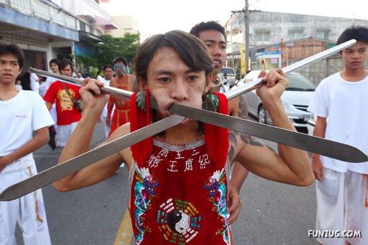 man with knives through his mouth