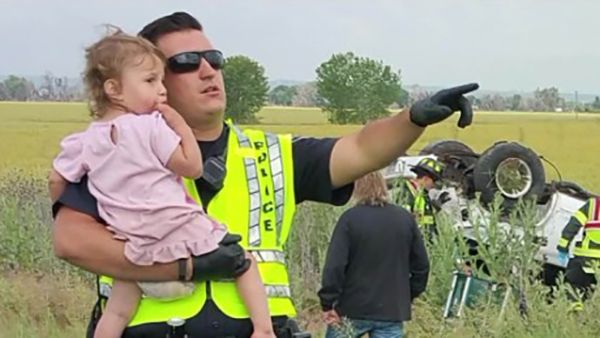 heartbreaking police photos. officer sings to baby after car crash