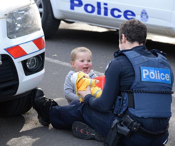 heartbreaking police photos. officer distracts boy when mother was trapped