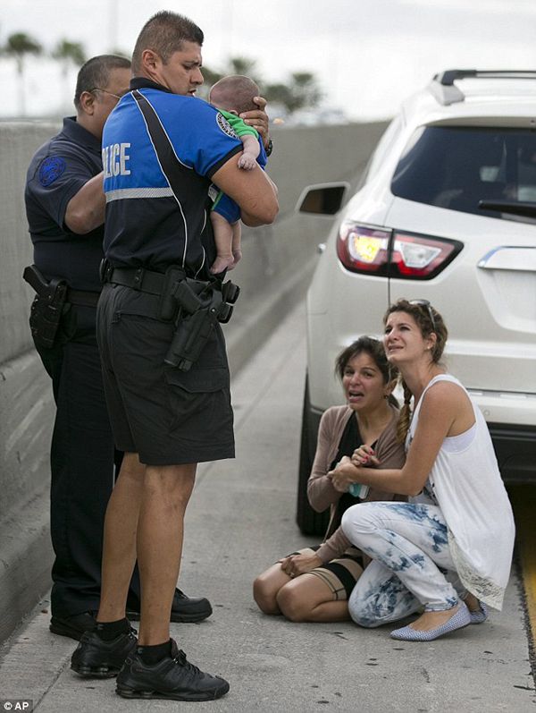 heartbreaking police photos. officer saves infant on highway with CPR