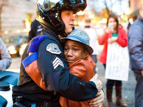 heartbreaking police photos. kid hugs cop at protest