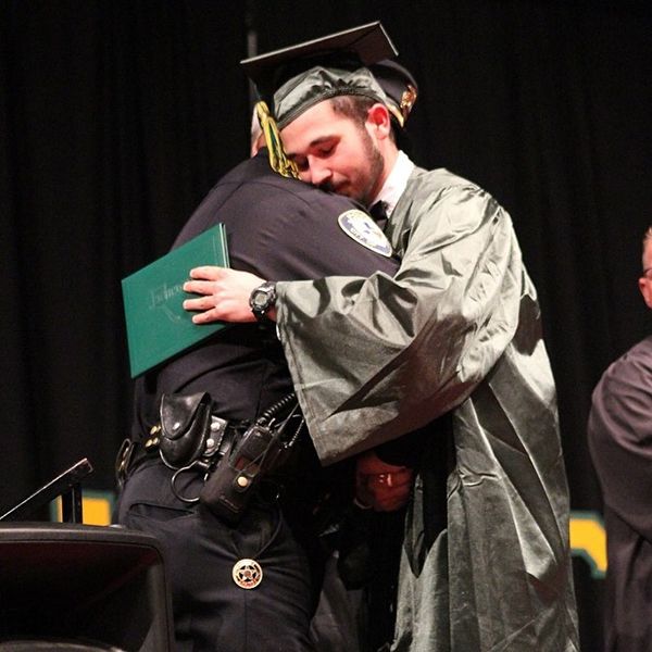 heartbreaking police photos. officer comes to boy's graduation after parents killed