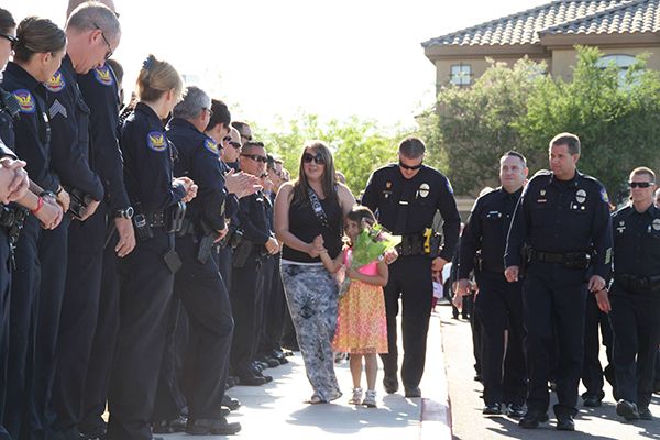 heartbreaking police photos. officers attend kindergarden graduation for fallen officer's daughter
