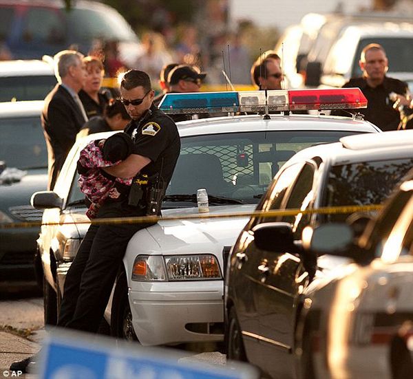 heartbreaking police photos. officer holds baby after mother and siblings murdered