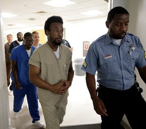 Inmates at the Suffolk County House of Correction at South Bay are escorted by a law enforcement official, Tuesday, June 26, 2018.