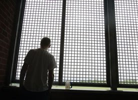An inmate stands on a balcony overlooking the Hudson Valley in a dementia unit at Fishkill State Prison in Fishkill, N.Y. (AP photo)