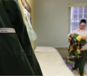 In this April 12, 2016 photo, Jennifer Dumas unfolds a quilt for her baby daughter who lives with her at Bedford Hills Correctional Facility, in Bedford Hills, N.Y. (AP Image)