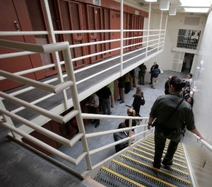 In this Aug. 17, 2011 file photo, reporters inspect one of the two-tiered cell pods in the Security Housing Unit at the Pelican Bay State Prison near Crescent City, Calif.