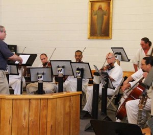 In this undated photo, string instrumentalists perform