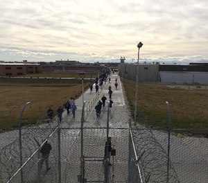 In this Jan. 30, 2018, photo inmates walk across the grounds of the Idaho State Correctional Institution in Kuna, Idaho.
