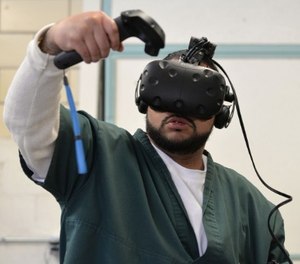 Leroy Gardenhire uses virtual reality inside the Fremont Correctional Facility in Cañon City to simulate doing laundry in a laundromat.