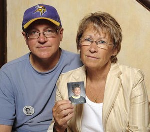 In this Aug. 28, 2009 file photo, Patty and Jerry Wetterling show a photo of their son Jacob Wetterling, who was abducted in October 1989 in St. Joseph, Minn and was still missing, in Minneapolis.