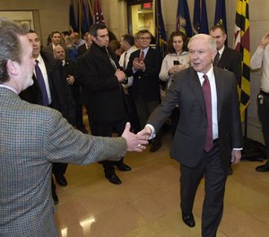 In this Feb. 9, 2017 file-pool photo, Attorney General Jeff Sessions is greeted by employees as he arrives at the Justice Department in Washington.