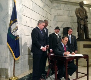 Kentucky Gov. Matt Bevin signs an executive order aimed at giving people with criminal records a
