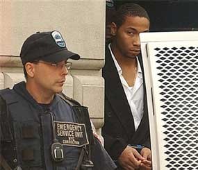 Ronell Wilson is escorted past a corrections officer after appearing in court in the Staten Island borough of New York, where he faced charges of shooting two undercover police officers during a buy-and-bust operation, in New York.