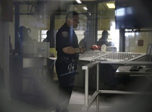 A corrections officer mans a security post in an enhanced supervision housing unit on Rikers Island in New York, Thursday, March 12, 2015. (AP Photo/Seth Wenig)