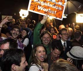 People attending an Amendment 64 watch party in a bar celebrate after a local television station announced the marijuana amendment's passage, in Denver, Colo., Tuesday. The amendment would make it legal in Colorado for individuals to possess and for businesses to sell marijuana for recreational use.