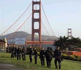California Highway Patrol members stand watch at the Golden Gate Bridge in preparation for possible May Day protests in San Francisco, Tuesday, April 1, 2012. Protesters had backed away from a call to block the bridge. But scores of California Highway Patrol officers nonetheless lined the span and gathered around the toll plaza this morning.