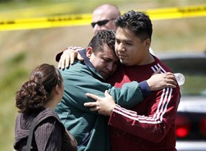 AP Photo/Charles Dharapak Marvin Chavez Quinteros, center, who discovered the bodies in his father's home, is comforted in Oxon Hill, Md., Tuesday, April 24, 2012. Five people are dead in a Maryland suburb of Washington of suspected carbon monoxide poisoning.