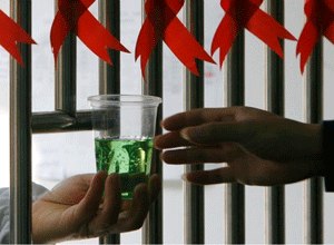 A drug addict receives a cup of methadone at a hospital in Nanjing, China.