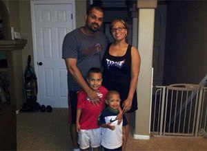 In this undated family photo provided by the Lima-Marin Family, Rene Lima Marin stands with his wife Jasmine and children Justus, 7, and Josiah, 4, at their home in Aurora, Colo. (AP Photo/Lima-Marin Family)
