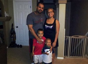 In this undated family photo provided by the Lima-Marin Family, Rene Lima Marin stands with his wife Jasmine and children Justus, 7, and Josiah, 4, at their home in Aurora, Colo. (AP Photo/Lima-Marin Family)