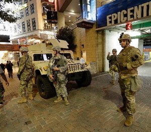 National Guardsman stand on the street in downtown Charlotte, N.C. on Thursday, Sept. 22, 2016. (AP Photo/Gerry Broome)