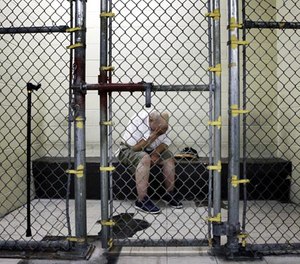 In this June 26, 2014 file photo, a U.S. veteran with post-traumatic stress sits in a segregated holding pen at the Cook County Jail after he was arrested on a narcotics charge in Chicago.