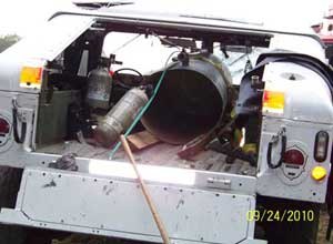 Photo NIOSH
Here is what's left of the water tank in the bed of the Humvee after the explosion. The bottom of the water tank separated and struck the hose reel, propelling the hose reel over the tailgate to strike and kill the victim.