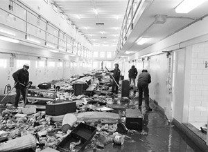 This Feb. 4, 1980 file photo shows guards at the New Mexico State Penitentiary cleaning up cell block six at the prison in Sante Fe, N.M. after a violent riot at the state's maximum-security penitentiary near Santa Fe. (AP Photo/Ed Andrieski, File)