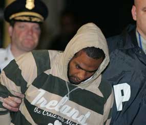 David Williams (also known as Daoud) is led by police officers from a federal building in New York after being arrested on charges related to a bombing plot in the Bronx. (AP Photo)