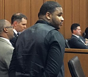 Douglas Shine Jr., front center, stands with attorneys as a verdict is read in his trial Friday, Nov. 4, 2016, at the Cuyahoga County Justice Center in Cleveland. Shine, accused of killing three people at a barbershop outside Cleveland, was found guilty on Friday of aggravated murder and other charges and could face the death penalty. (AP Photo/Mark Gillispie)
