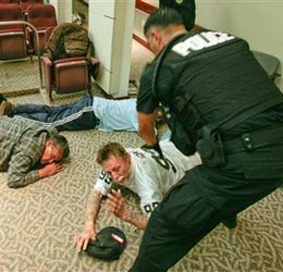 At-large parolees are arrested in an auditorium during a sting operation at the California State Building in Oakland, Calif. on Saturday, May 15, 2010. (AP photo)