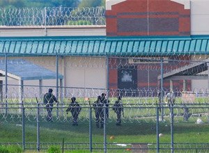 Armed personnel patrol the grounds of the Tecumseh State Correctional Institution, in Tecumseh, Neb., Monday, May 11, 2015.