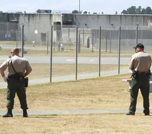 In this Aug. 17, 2011 file photo, correctional officers keep watch on inmates in the recreation yard at Pelican Bay State Prison near Crescent City, Calif. (AP Photo/Rich Pedroncelli, File)